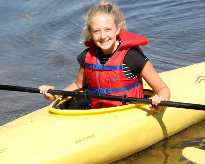 Young girl in kayak on a New Hampshire lake